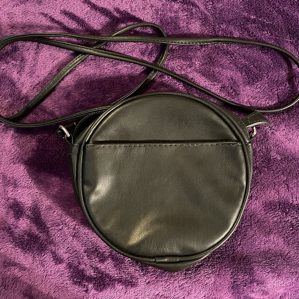 New, never used small black round crossbody bag with no brand name